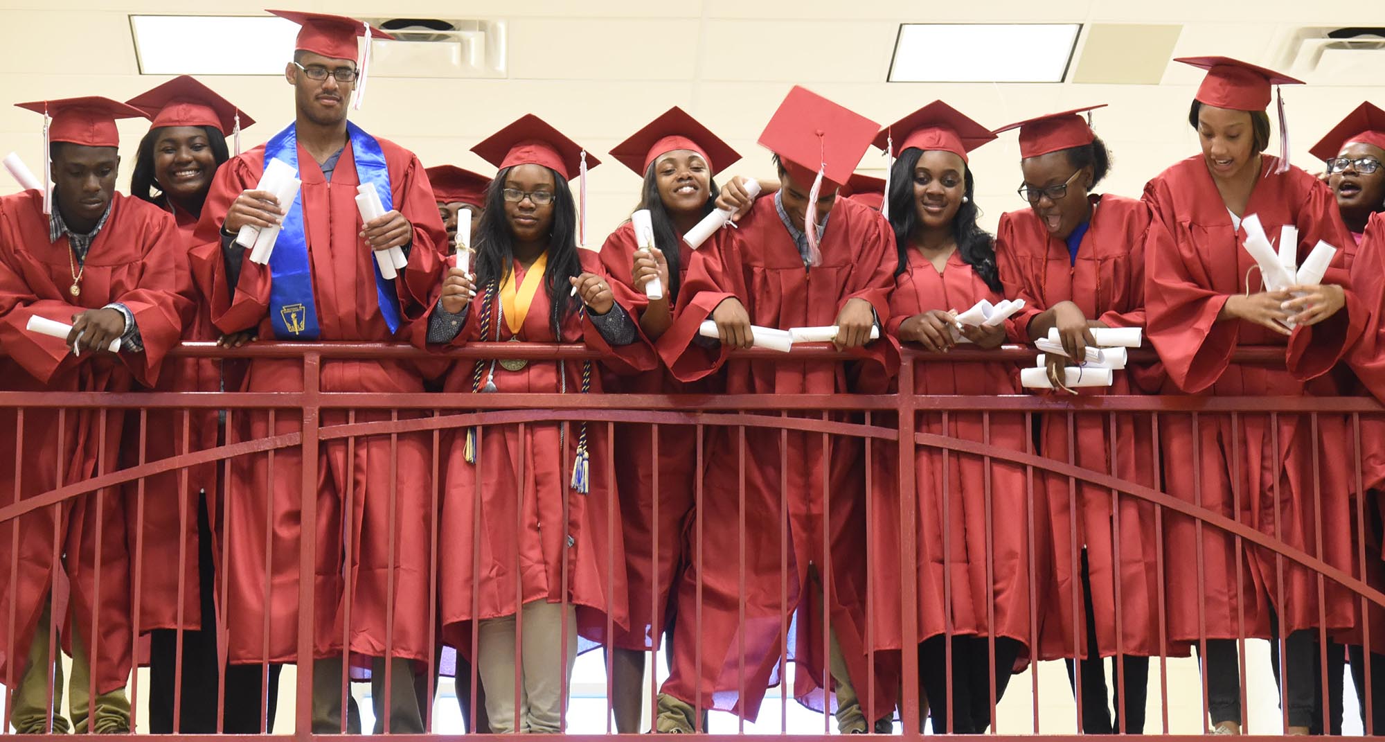 Brainerd Seniors look down from the second floor of Orchard Knob Elementary as they wait to have a group photo made. The 2016 graduating class of Brainerd High School walked through the halls of Orchard Knob Elementary in their caps and gowns, as a representation of the "vision" for where the elementary students will one day be.