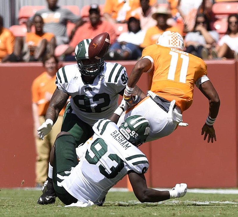 Tennessee quarterback Joshua Dobbs (11) fumbles the ball after he was hit by Ohio's Terell Basham (93), Bobcat teammate Cleon Aloese (92) looks on.  The Ohio University Bobcats visited the University of Tennessee Volunteers at Neyland Stadium in a non-conference NCAA football game on Saturday September 17, 2016. 