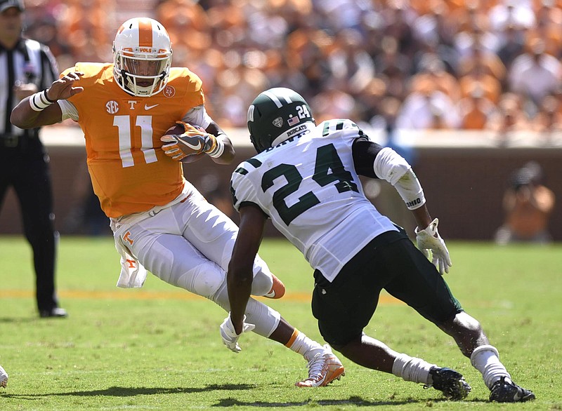Tennessee quarter back Joshua Dobbs (11) tries to avoid the tackle of Ohio's Toran Davis (24).  The Ohio University Bobcats visited the University of Tennessee Volunteers at Neyland Stadium in a non-conference NCAA football game on Saturday September 17, 2016. 