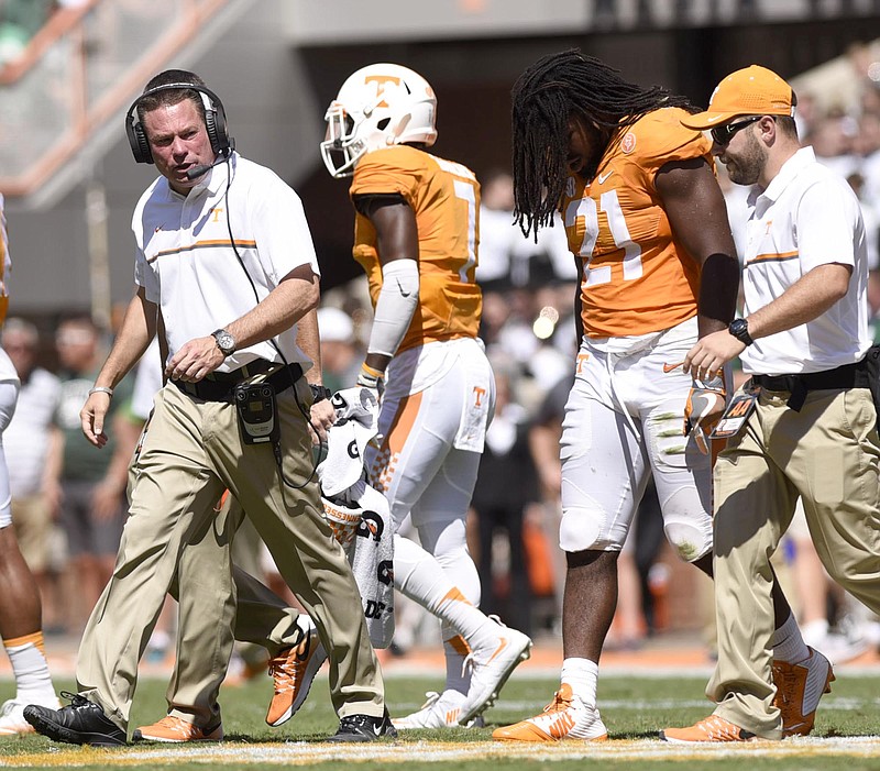 Tennessee head coach Butch Jones leaves the field with a injured Jalen Reeves-Maybin (21).  The Ohio University Bobcats visited the University of Tennessee Volunteers at Neyland Stadium in a non-conference NCAA football game on Saturday September 17, 2016. 