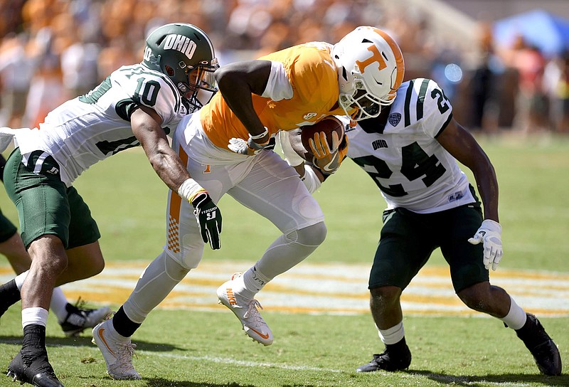 Tennessee's Preston Williams (7) picks up yardage after a pass reception, while Ohio's Randy Stites (10) and Toran Davis (24) defend.  The Ohio University Bobcats visited the University of Tennessee Volunteers at Neyland Stadium in a non-conference NCAA football game on Saturday September 17, 2016. 