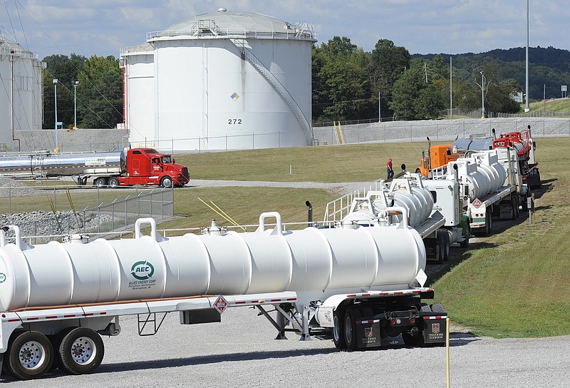 Tanker trucks line up at a Colonial Pipeline Co. facility in Pelham, Ala., near the scene of a 250,000-gallon gasoline spill on Friday, Sept. 16, 2016. The company says spilled gasoline is being taken to the storage facility for storage. Some motorists could pay a little more for gasoline in coming days because of delivery delays. (AP Photo/Jay Reeves)