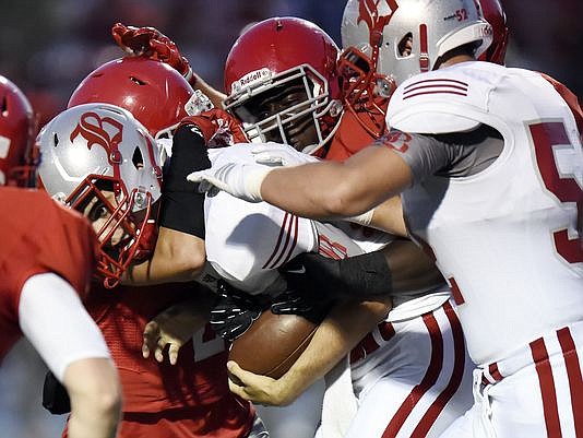 Baylor quarterback Lorenzo White, center, is sacked by Brentwood Academy defenders during first half of an high school football game on Friday, Sept. 16, 2016, in Brentwood, Tenn. (Photo: Mark Zaleski / For The Tennessean)