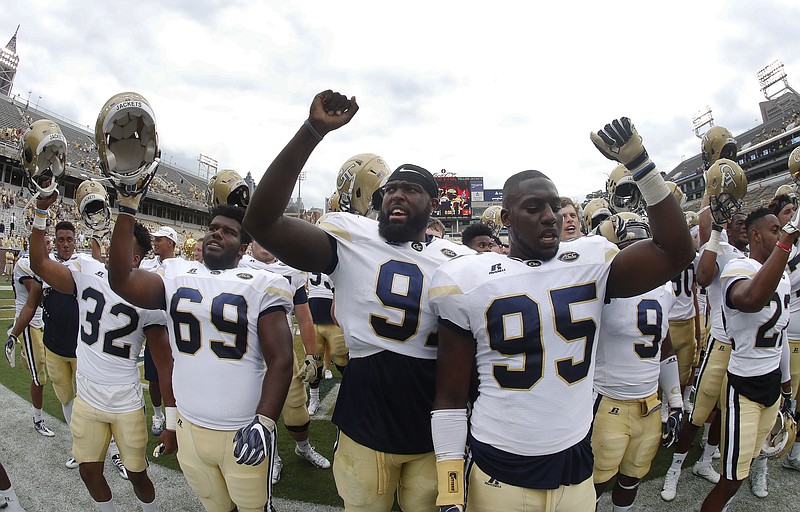 Georgia Tech defensive linemen Patrick Gamble (91) and Tyler Merriweather (95) lead the crowd in singing the school fight song after defeating Vanderbilt 38-7 in an NCAA college football game Saturday, Sept. 17, 2016, in Atlanta. (AP Photo/John Bazemore)