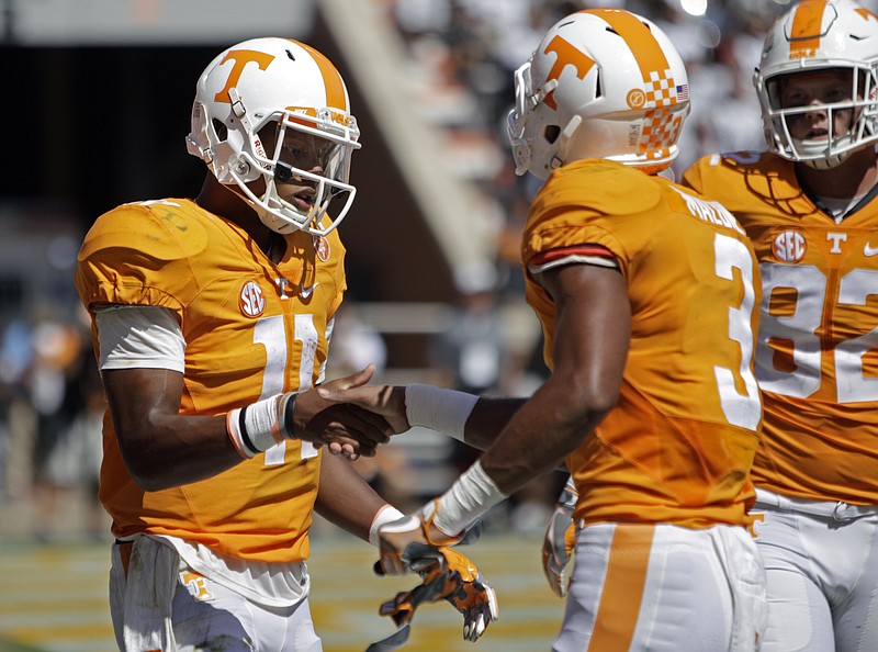 Tennessee quarterback Joshua Dobbs (11) congratulates wide receiver Josh Malone (3) after scoring a touchdown in the second half of an NCAA college football game against Ohio Saturday, Sept. 17, 2016, in Knoxville, Tenn. Tennessee won 28-19. (AP Photo/Wade Payne)
