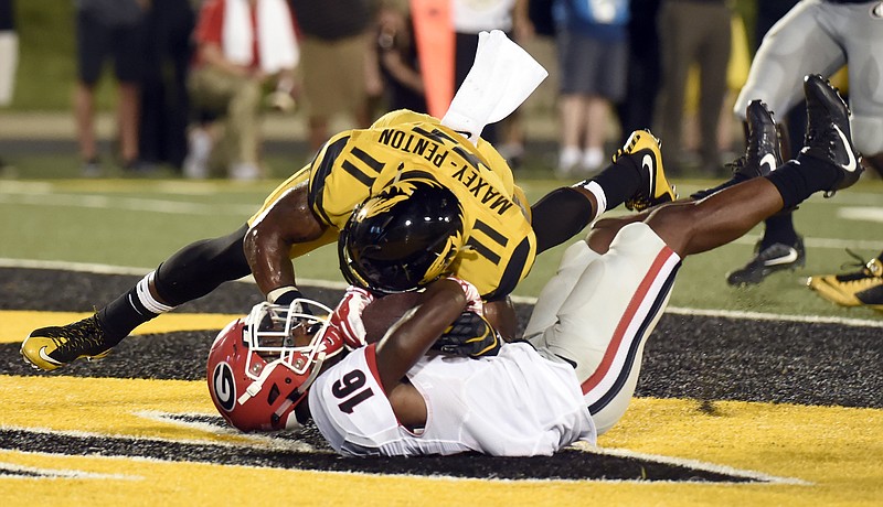 Georgia wide receiver Isaiah McKenzie, bottom, catches a touchdown pass against Missouri defensive back Aarion Penton during the second half of an NCAA college football game Saturday, Sept. 17, 2016, in Columbia, Mo. Georgia won 28-27. (AP Photo/L.G. Patterson)