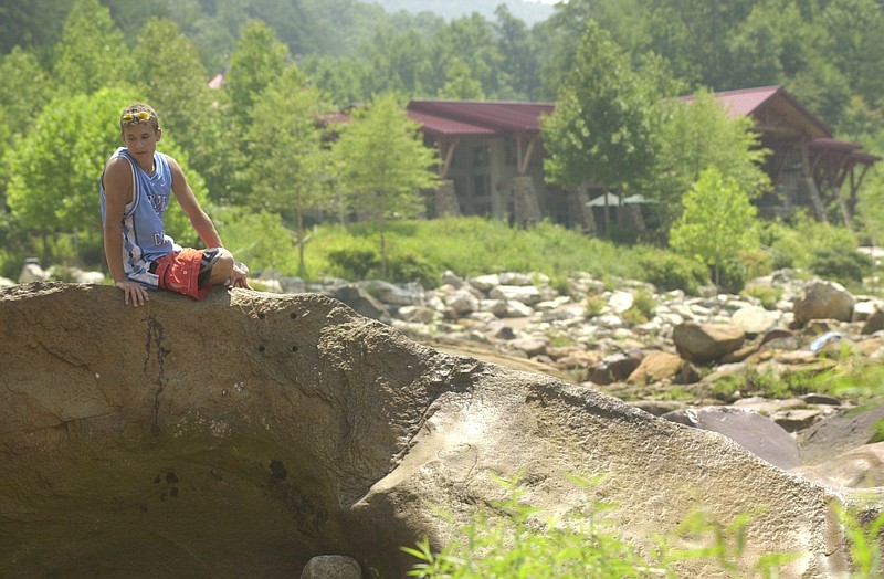 Alex Donehoo from Murphy, North Carolina, rests on a boulder in the Olympic whitewater course next to the Ocoee Whitewater Center Thursday afternoon.  When water is released into the course it becomes a world-class whitewater run used in rodeo and slalom competitions.  