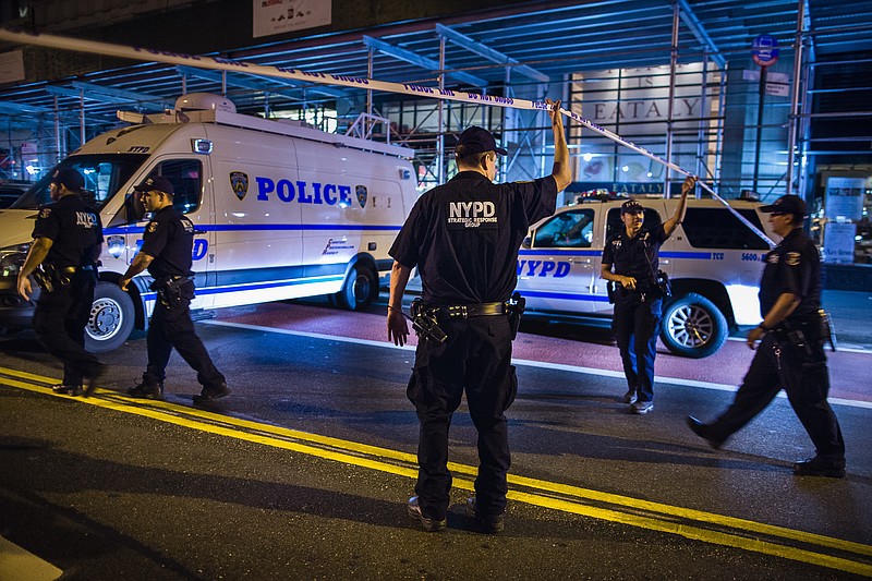 
              Police arrive on the scene of an explosion in Manhattan's Chelsea neighborhood, in New York, Saturday, Sept. 17, 2016. A law enforcement official tells The Associated Press that an explosion in the Chelsea neighborhood appears to have come from a construction toolbox in front of a building. The official spoke on condition of anonymity because the person wasn't authorized to speak about an ongoing investigation. Police say 26 people have sustained minor injuries in the explosion on West 23rd Street. (AP Photo/Andres Kudacki)
            