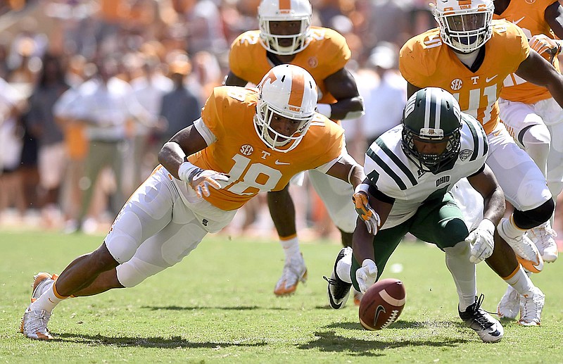 Tennessee's Nigel Warrior (18) and Ohio's Papi White (4) go after a fumbled Ohio punt return. White recovered the ball in Saturday's game at Neyland Stadium, and Tennessee has been even more fortunate on its fumbles this year, having lost only one of 11.