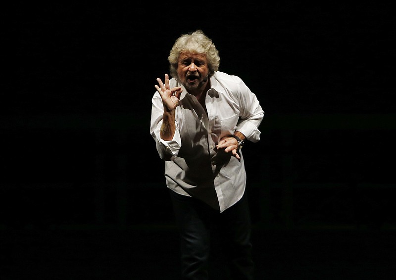 
              FILE - In this Tuesday Feb. 2, 2016 file photo, Beppe Grillo, leader of the anti-establishment 5-Stars Movement, performs in Milan, Italy. The day the anti-establishment 5-Star Movement triumphed in Rome’s mayoral election, its exultant founder, comic Beppe Grillo, immediately turned his supporters’ sights on the next destination for what he calls their ‘’mission impossible airplane”  soaring into national power.  (AP Photo/Antonio Calanni, File)
            