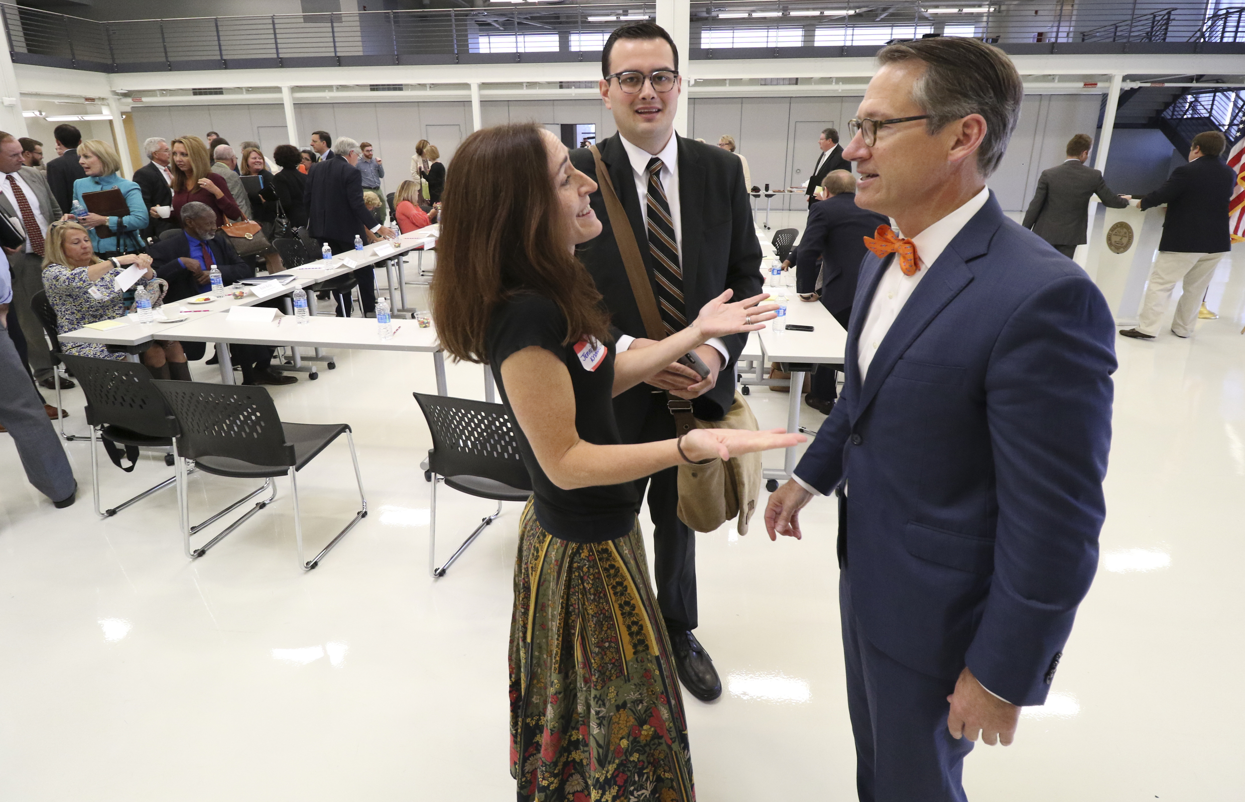 Staff Photo by Dan Henry / The Chattanooga Times Free Press- 9/20/16. Jennifer Knowles, Jonas Barriere and Senator Bo Watson, from left, converse at the conclusion of the Education Mini-Summit 2016 at the Volkswagen Conference Center on September 20, where Tennessee legislators from Hamilton County and local education officials discussed the county's public school system. The district is producing lower-than-expected test results and have Teacher's rated least effective by state measures.