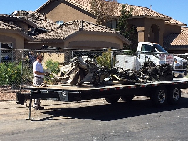 
              Wreckage from a plane that crashed into a home in Gilbert, Ariz., sits on a flatbed on Sunday, Sept. 18, 2016. Federal investigators are trying to determine what led the plane carrying several skydivers to crash Saturday. The pilot and four skydivers were able to parachute out before the aircraft struck the house.  (Gary Hildebrandt/Gilbert Fire Department via AP)
            