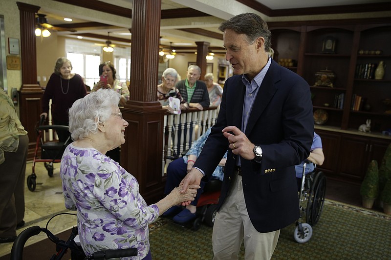 
              FILE - In this Aug. 30, 2016, file photo, Democratic U.S. Senate candidate Evan Byah talks with Claire Rothenbuhler as he campaigned in a senior living community in Indianapolis. Bayh was Democrats’ prize Senate recruit this election cycle, a popular former senator and governor with a huge war chest and sky-high name ID in his home state. Top Democrats heralded his surprise entrance into the race in July with hopes that Republicans would abandon his little-known and underfunded GOP rival, Rep. Todd Young, and give up on Indiana. Instead, outside GOP groups including the Chamber of Commerce and the billionaire Koch Brothers have poured some $10 million into the race, eroding Bayh’s fund-raising advantage and closing his lead over Young to low- or mid-single digits.  (AP Photo/Michael Conroy, File)
            