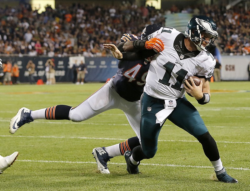 Philadelphia Eagles quarterback Carson Wentz (11) runs against Chicago Bears outside linebacker Sam Acho (49) during the first half of an NFL football game, Monday, Sept. 19, 2016, in Chicago. 