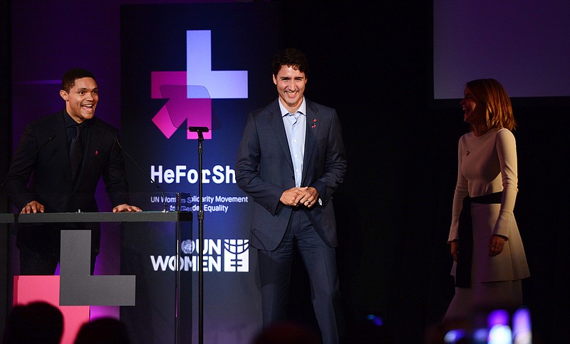 
              Canadian Prime Minister Justin Trudeau, center, shares a laugh with Trevor Noah, left, host of "The Daily Show" and actress Emma Watson prior to delivering a speech as he attends a reception on the occasion of the 2nd Anniversary of "HeForShe" in New York, Tuesday, Sept. 20, 2016.  (Sean Kilpatrick/The Canadian Press via AP)
            
