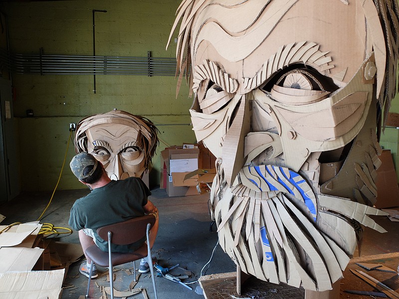 Artist Wayne White works on the cardboard face of Confederate General Patrick Cleburne for Saturday's Glass Street LIVE parade. The oversize puppets, fifteen-feet-tall, will be used to commemorate the Centennial of the National Park Service.