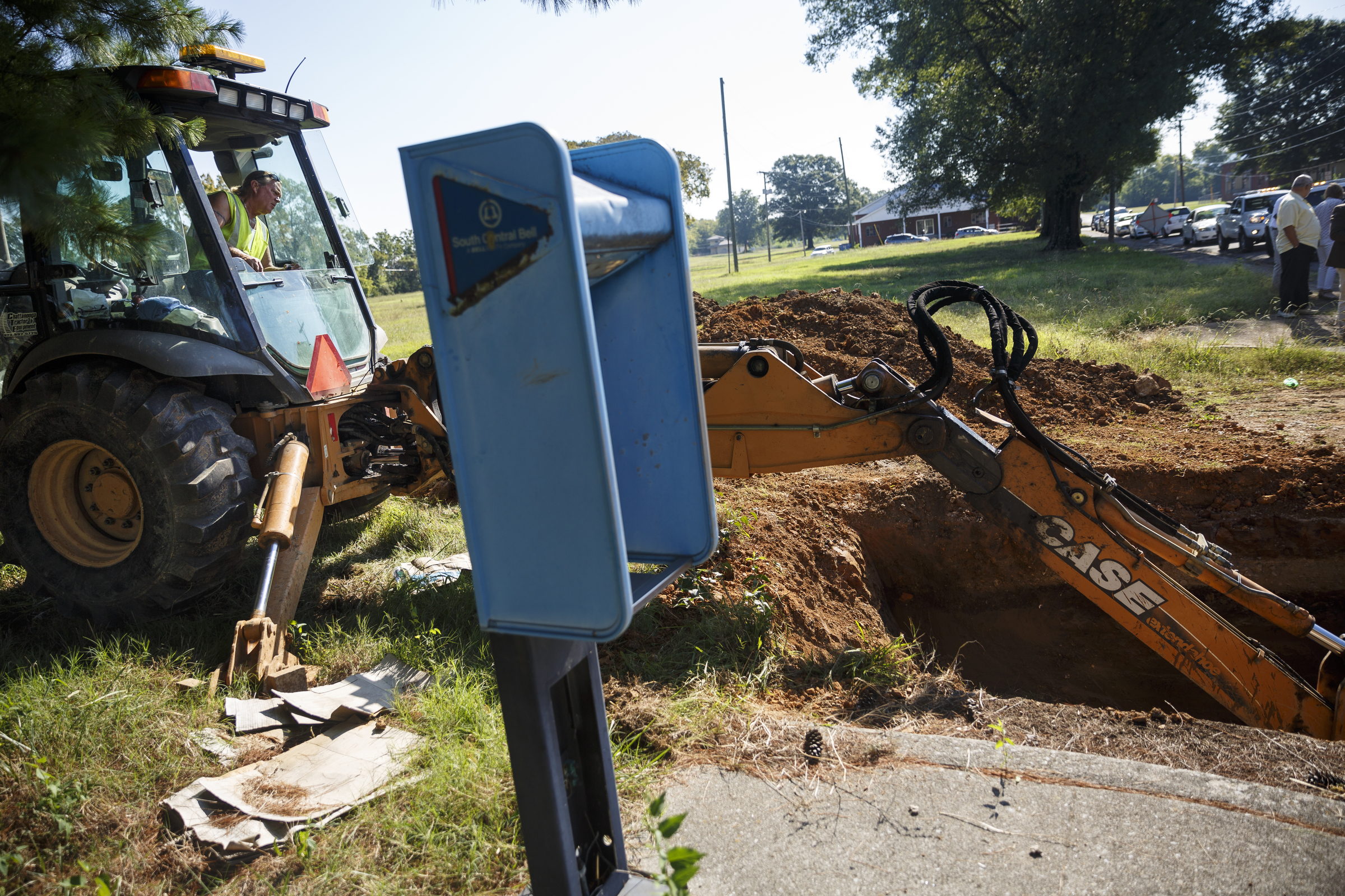 Tennessee American Water worker Jack Derryberry uses an excavator to take an old water main out of service so new construction can begin at the old site of Maurice Poss Homes near Howard School on Wednesday, Sept. 21, 2016, in Chattanooga, Tenn. Officials hope to use the site to build a new stadium for Howard.