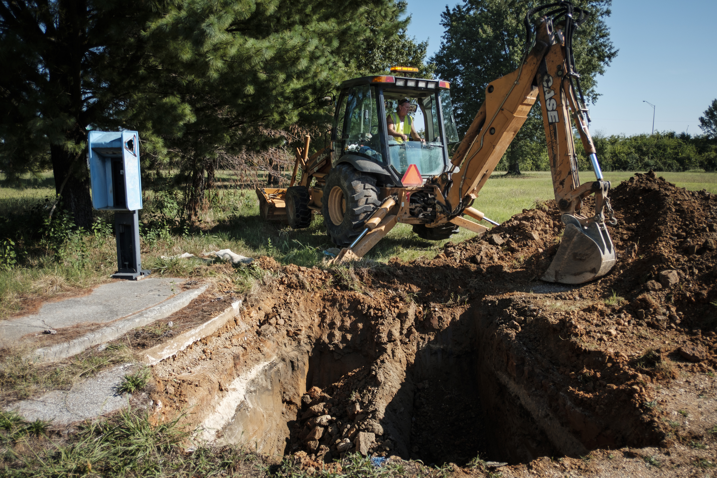 Tennessee American Water worker Jack Derryberry uses an excavator to take an old water main out of service so new construction can begin at the old site of Maurice Poss Homes near Howard School on Wednesday, Sept. 21, 2016, in Chattanooga, Tenn. Officials hope to use the site to build a new stadium for Howard.