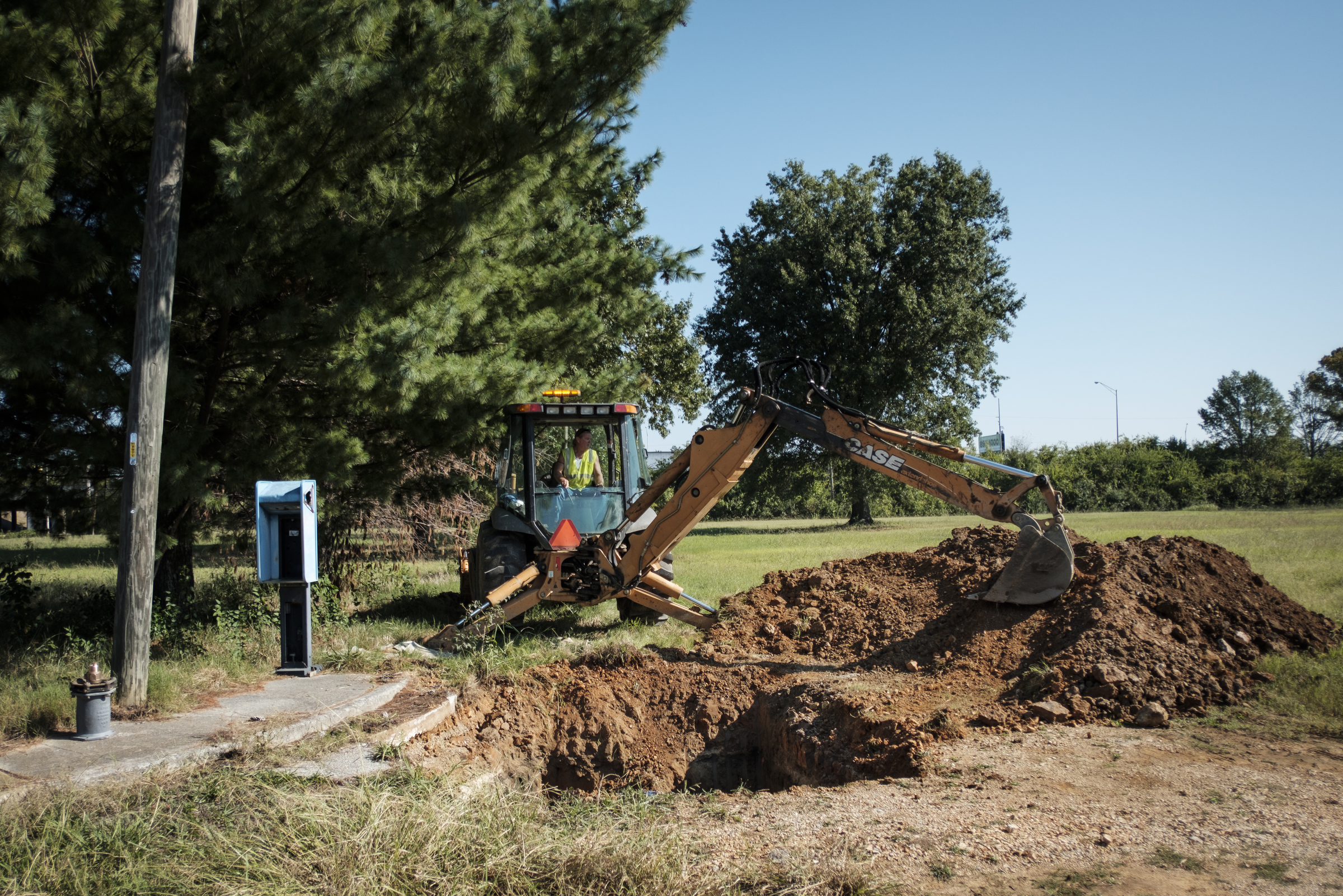Tennessee American Water worker Jack Derryberry uses an excavator to take an old water main out of service so new construction can begin at the old site of Maurice Poss Homes near Howard School on Wednesday, Sept. 21, 2016, in Chattanooga, Tenn. Officials hope to use the site to build a new stadium for Howard.