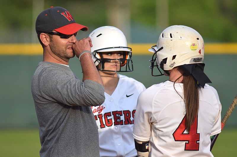 Derrin Easterly confers with Whitwell softball players during a game in 2015, when he was the team's head coach. Easterly, who played high school baseball at Marion County, is now the baseball coach at Sequatchie County.