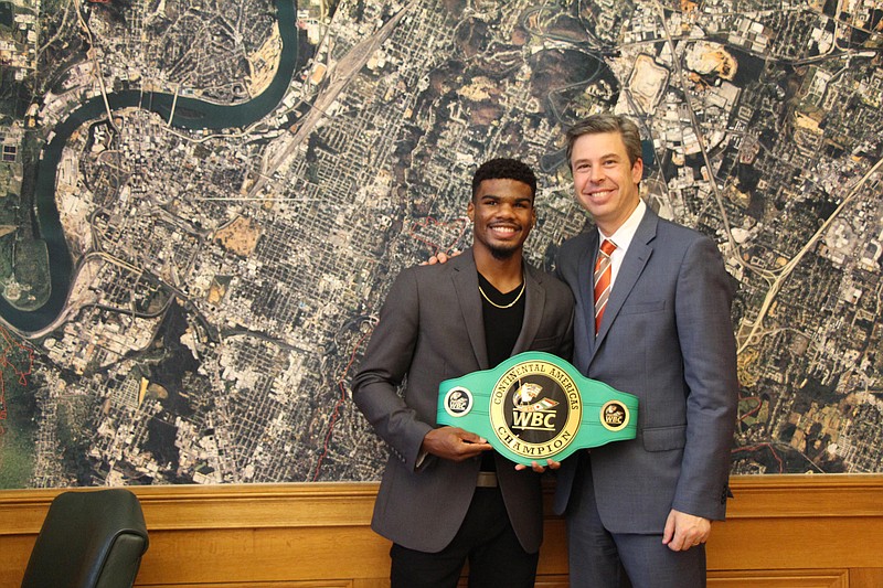 Chattanooga native Ryan Martin, an undefeated professional boxer, poses with his WBC Continental Americas championship belt and Mayor Andy Berke as part of his recognition from the city Tuesday evening.