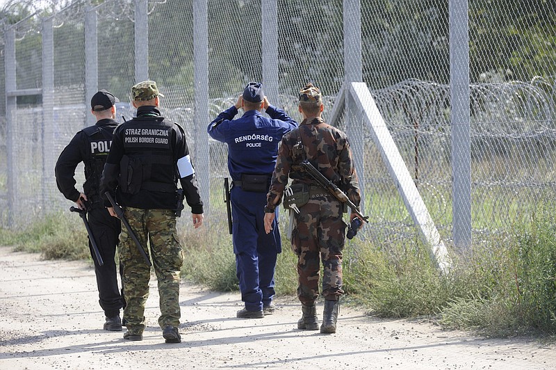 
              Hungarian and Polish soldiers and policemen patrol the Hungarian-Serbian border near Roszke, 180 kms southeast of Budapest, Hungary, Tuesday, Sept. 20, 2016. Two days earlier forty-nine Polish officers, including twenty-five policemen and twenty-four border guards arrived to Hungary to assist their Hungarian colleagues with border defence until October 29. The Polish contingent fulfills duty as part of the cooperation between the Visegrad Group (V4) countries. (Zoltan Gergely Kelemen/MTI via AP)
            