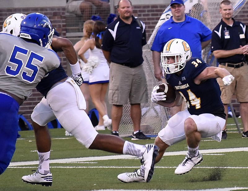 UTC's Derrick Craine (34) cuts behind his blocking.  The University of Tennessee/Chattanooga Mocs hosted the Shorter University Hawks in NCAA football action on Sept. 1, 2016. 