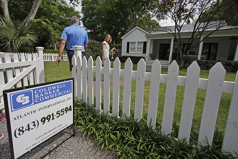 In this Wednesday, April 20, 2016, photo, real estate agent Lauren Newman, right, prepares to show Steve Martin, a home for sale in Mount Pleasant, S.C., just over the bridge from historic Charleston. On Thursday, Sept. 22, 2016, the National Association of Realtors reports on sales of existing homes in August. (AP Photo/Chuck Burton)