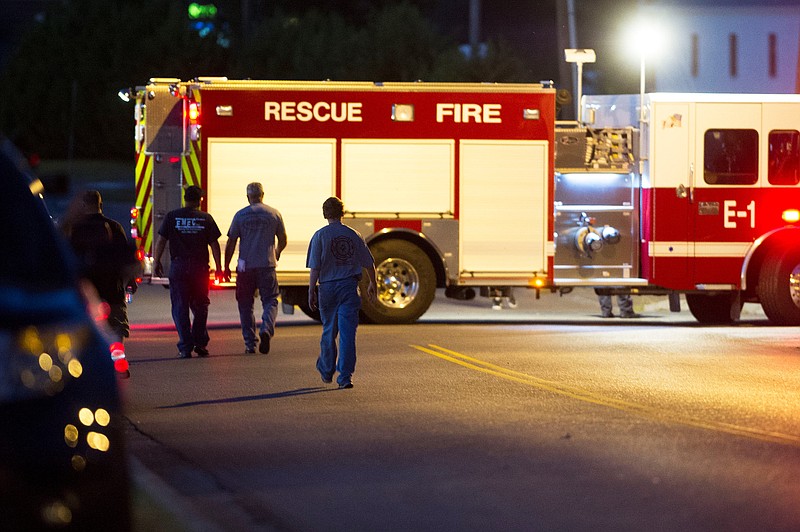 Men walk towards a firetruck outside of Thomas & Betts Corporation where earlier today a shooting took place which left three dead in Athens, Tennessee on Thursday Sept. 22, 2016. (CAITIE MCMEKIN/NEWS SENTINEL)
