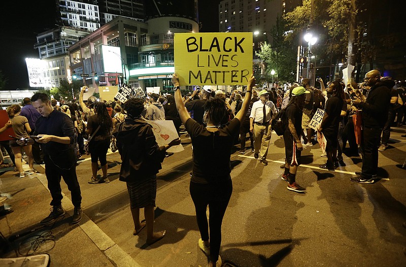 Protesters take to the streets of uptown during a peaceful march following Tuesday's police shooting of Keith Lamont Scott in Charlotte, N.C., Thursday, Sept. 22, 2016. (AP Photo/Gerry Broome)