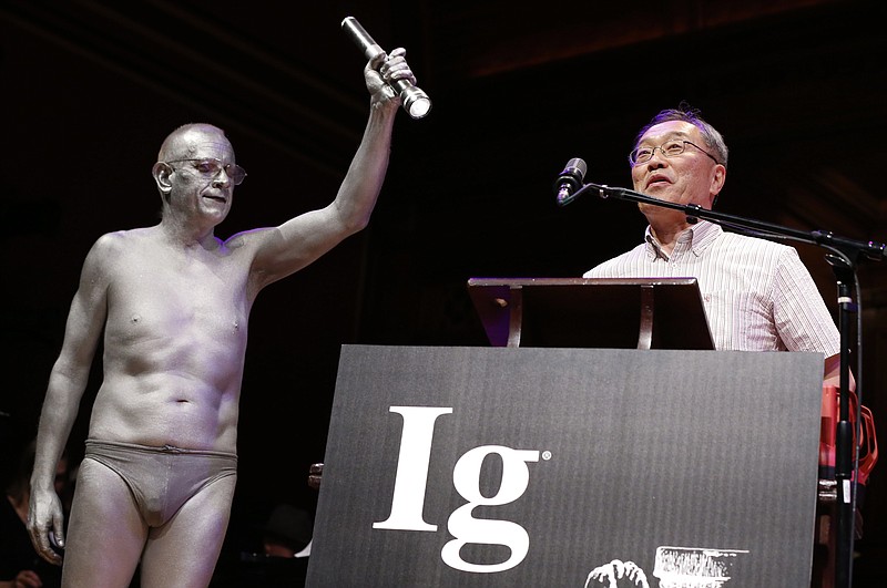 
              Atsuki Higashiyama, from Ritsumeikan University in Japan, speaks after receiving the Ig Nobel Perception Prize during ceremonies at Harvard University in Cambridge, Mass., Thursday, Sept. 22, 2016. Higashiyama was awarded the prize for investigating whether things look different when you bend over and view them between your legs. (AP Photo/Michael Dwyer)
            