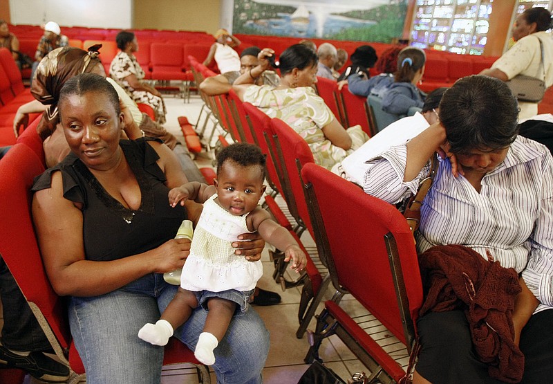 
              FILE - In this Thursday, Jan. 21, 2010, file photo, Haitian national Carole Manigat, left, holds her daughter Hadassa Carole Albert as she waits for her turn to fill out temporary protective status papers at Notre Dame d'Haiti Catholic Church in the Little Haiti neighborhood in Miami. The U.S. Department of Homeland Security said Thursday, Sept. 22, 2016, that it was widening efforts to deport Haitians, a response to thousands of immigrants from the Caribbean nation who have overwhelmed California border crossings with Mexico in recent months. The move lifts special protections that shielded Haitians from deportation after their nation’s 2010 earthquake. (AP Photo/Alan Diaz, File)
            