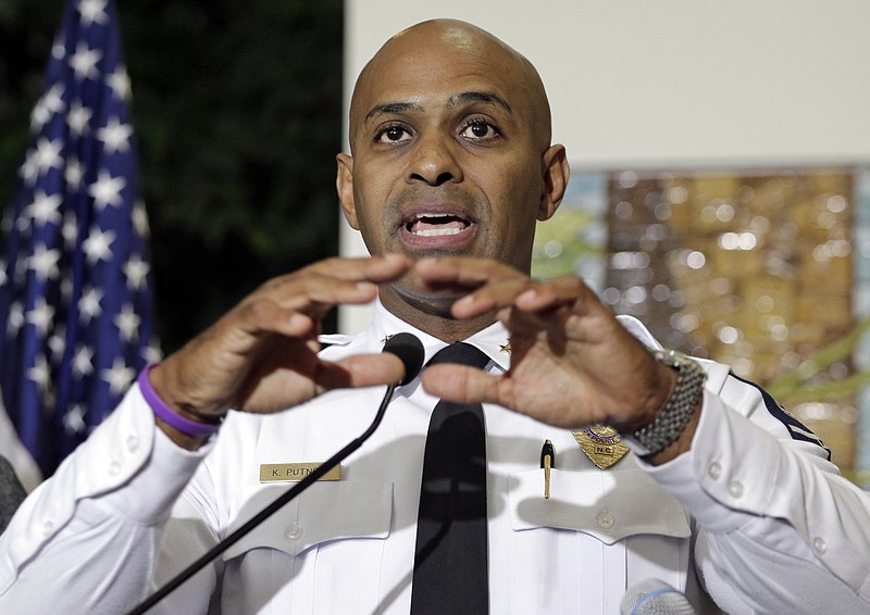 Charlotte-Mecklenburg Police chief Police Chief Kerr Putney gestures as he answers a question during a news conference after a second night of violence following Tuesday's fatal police shooting of Keith Lamont Scott in Charlotte, N.C. Thursday, Sept. 22, 2016. Putney plans to show video of an officer shooting Scott to the slain man's family, but the video won't be immediately released to the public. 