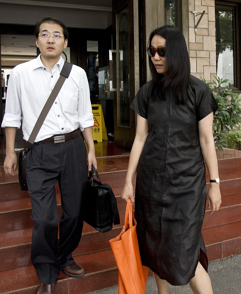 
              FILE - In this July 14, 2011, file photo, lawyer Xia Lin, left, walks with Lu Qing, wife of outspoken Chinese artist Ai Weiwei, as they head to the Beijing Local Taxation Bureau. Xia, a Chinese lawyer who defended activists and others involved in politically sensitive cases, was sentenced to 12 years in prison, Thursday, Sept. 22, 2016, on fraud charges his lawyers said in what is believed to be the harshest penalty rendered in years against those few willing to take on the ruling Communist Party. (AP Photo/Andy Wong, File)
            