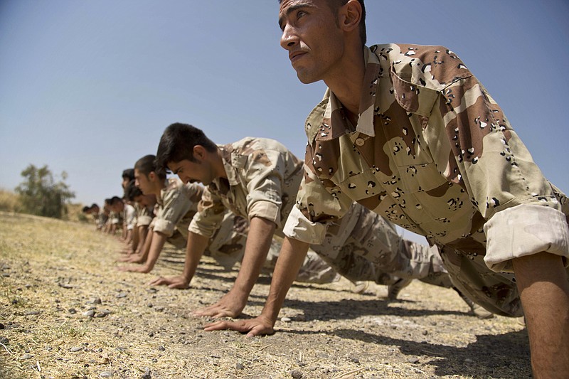 
              In this Wednesday, Sept. 21, 2016 photo, new recruits of the Democratic Party of Iranian Kurdistan train at their base in Koya, northern Iraq. The main Kurdish opposition group in Iran will keep up its guerrilla campaign against security forces “to protect and defend” Kurds living there. That’s according to the deputy leader of the Democratic Party of Iranian Kurdistan. He calls the fight necessary after the Islamic Republic’s nuclear deal with world powers.(AP Photo/Maya Alleruzzo)
            