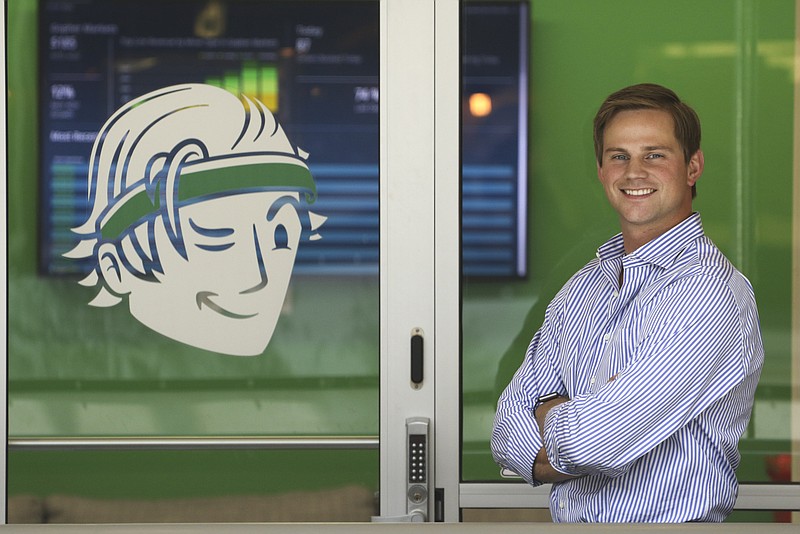 Cameron "Cam" Doody, cofounder and president of Bellhops, stands outside of his company's office in Warehouse Row.