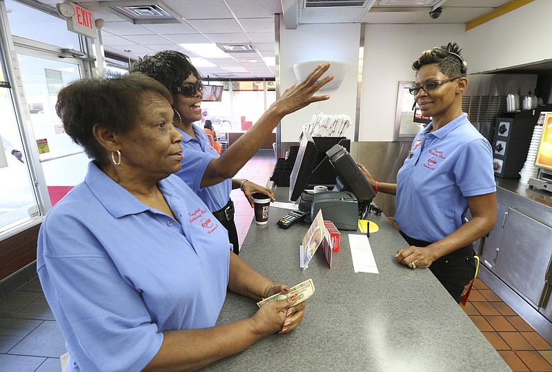 Staff Photo by Dan Henry / The Chattanooga Times Free Press- 9/22/16. Alma Carter and Tina Lindsay, from left,  order breakfast from General Manager Trella Neal before meeting up with members of the Krystal Birthday Club off of Highway 58 on Thursday, September 22, 2016. 