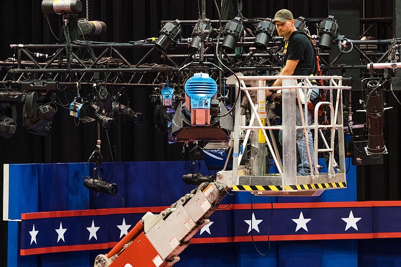 
              A technician examines the lighting grid as preparations continue for Monday's first debate presidential between Democratic Hillary Clinton and Republican Donald Trump, Saturday, Sept. 24, 2016, at Hofstra University in Hempstead, N.Y.  (AP Photo/J. David Ake)
            