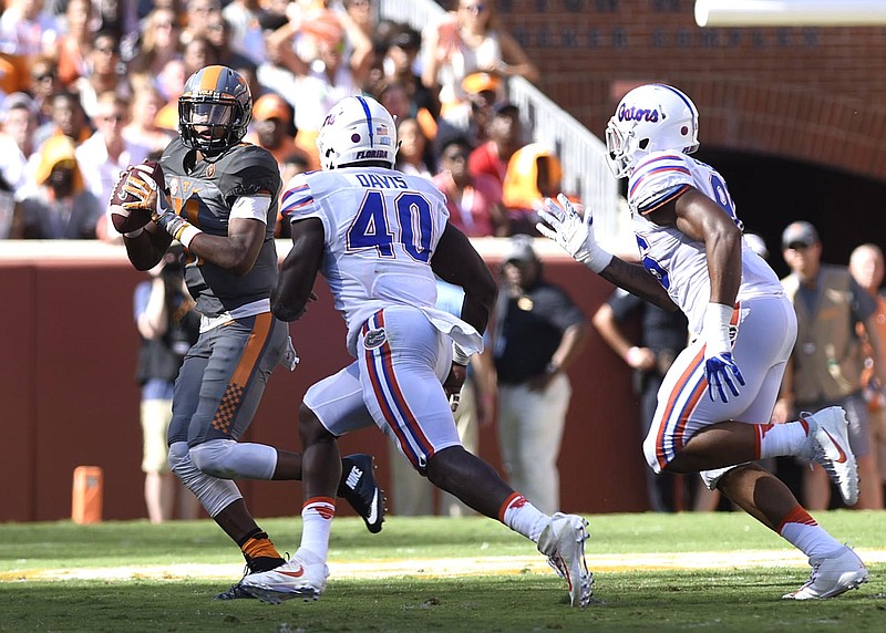 Staff Photo by Robin Rudd
Tennessee's Joshua Dobbs (11) looks to pass while be hurried by the Gator defense. The Florida Gators visited the Tennessee Volunteers in a important SEC football contest at Neyland Stadium on September 24, 2016.