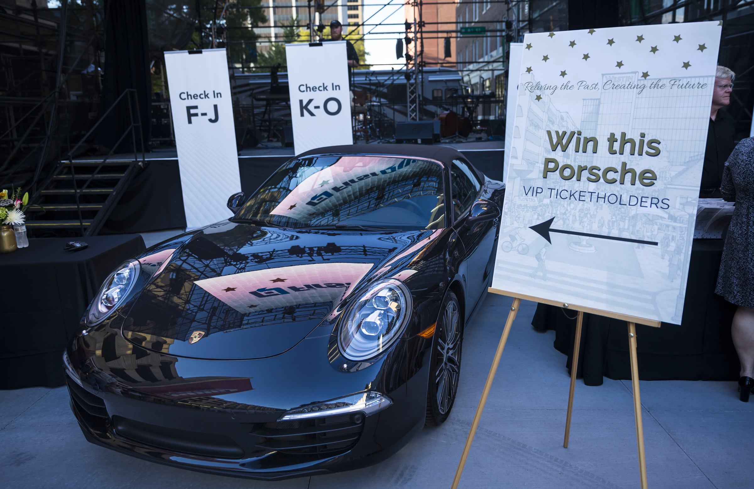A 2016 Porche is displayed as a raffle prize at the "Remembering the Past, Celebrating the Future" fundraiser to raise money for WTCI held on the newly repaved section of Chestnut Street between Martin Luther King, Jr., Boulevard and 8th Street on Saturday, Sept. 24, 2016, in Chattanooga, Tenn. The fundraiser featured music from Arlo Guthrie, the Dismembered Tennesseans, and Priscilla and Little Rickee.