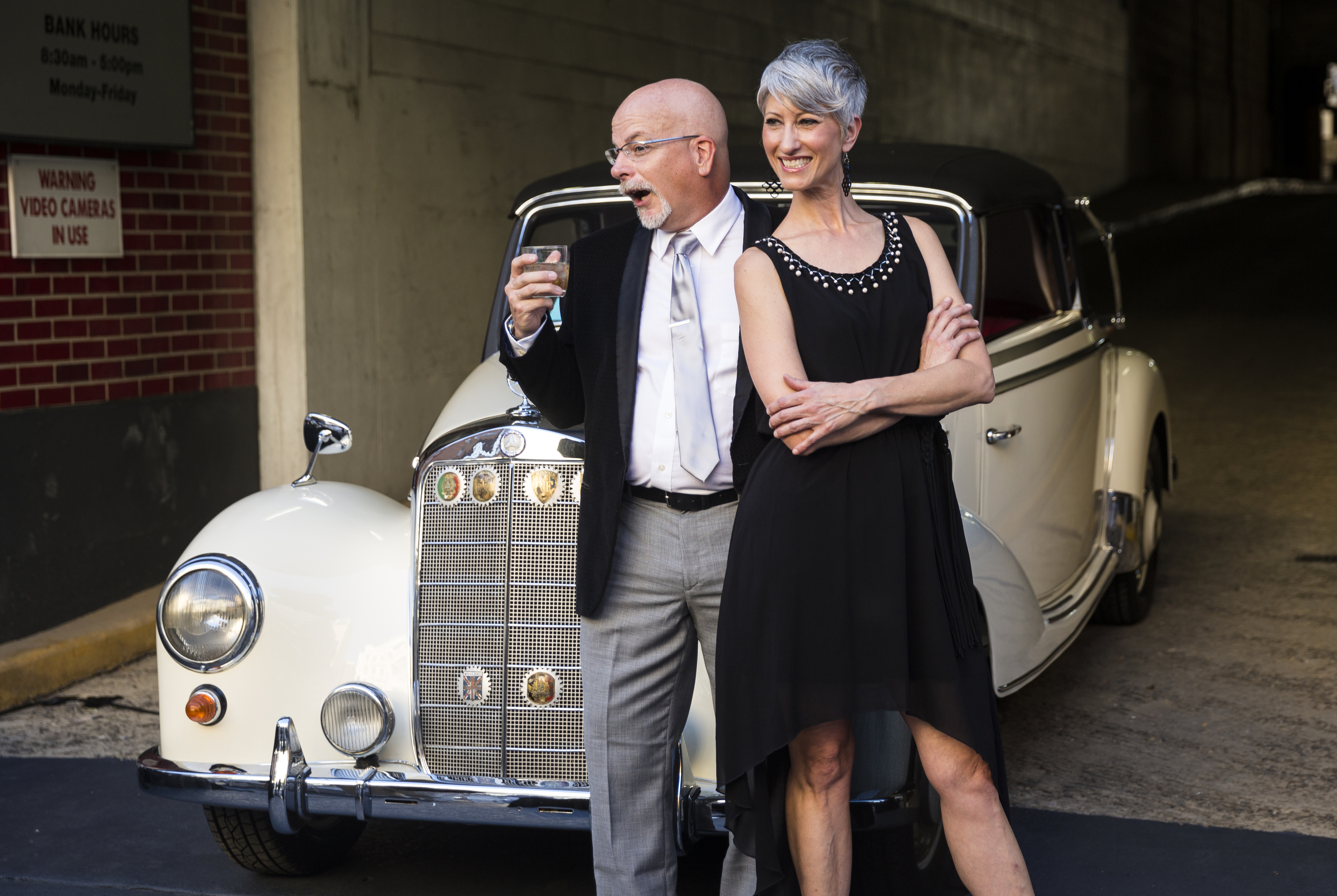 Doug Wright, left, and Darin Wright pose in front of a classic Mercedes for a photo booth at the "Remembering the Past, Celebrating the Future" fundraiser to raise money for WTCI held on the newly repaved section of Chestnut Street between Martin Luther King, Jr., Boulevard and 8th Street on Saturday, Sept. 24, 2016, in Chattanooga, Tenn. The fundraiser featured music from Arlo Guthrie, the Dismembered Tennesseans, and Priscilla and Little Rickee.