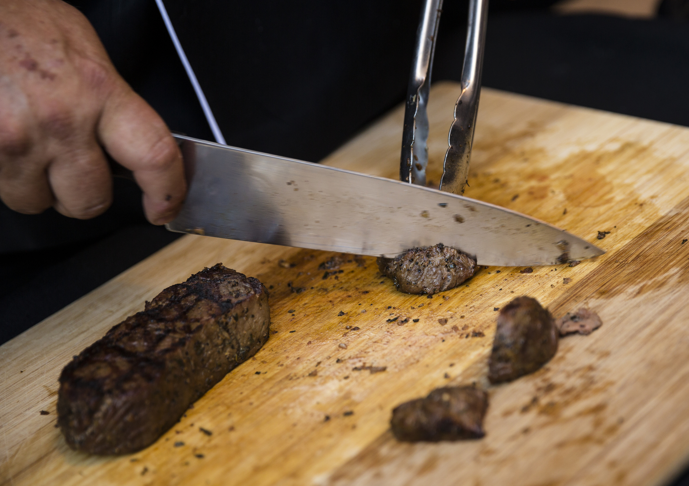 A server cuts steak at the "steak bar" at the "Remembering the Past, Celebrating the Future" fundraiser to raise money for WTCI held on the newly repaved section of Chestnut Street between Martin Luther King, Jr., Boulevard and 8th Street on Saturday, Sept. 24, 2016, in Chattanooga, Tenn. The fundraiser featured music from Arlo Guthrie, the Dismembered Tennesseans, and Priscilla and Little Rickee.