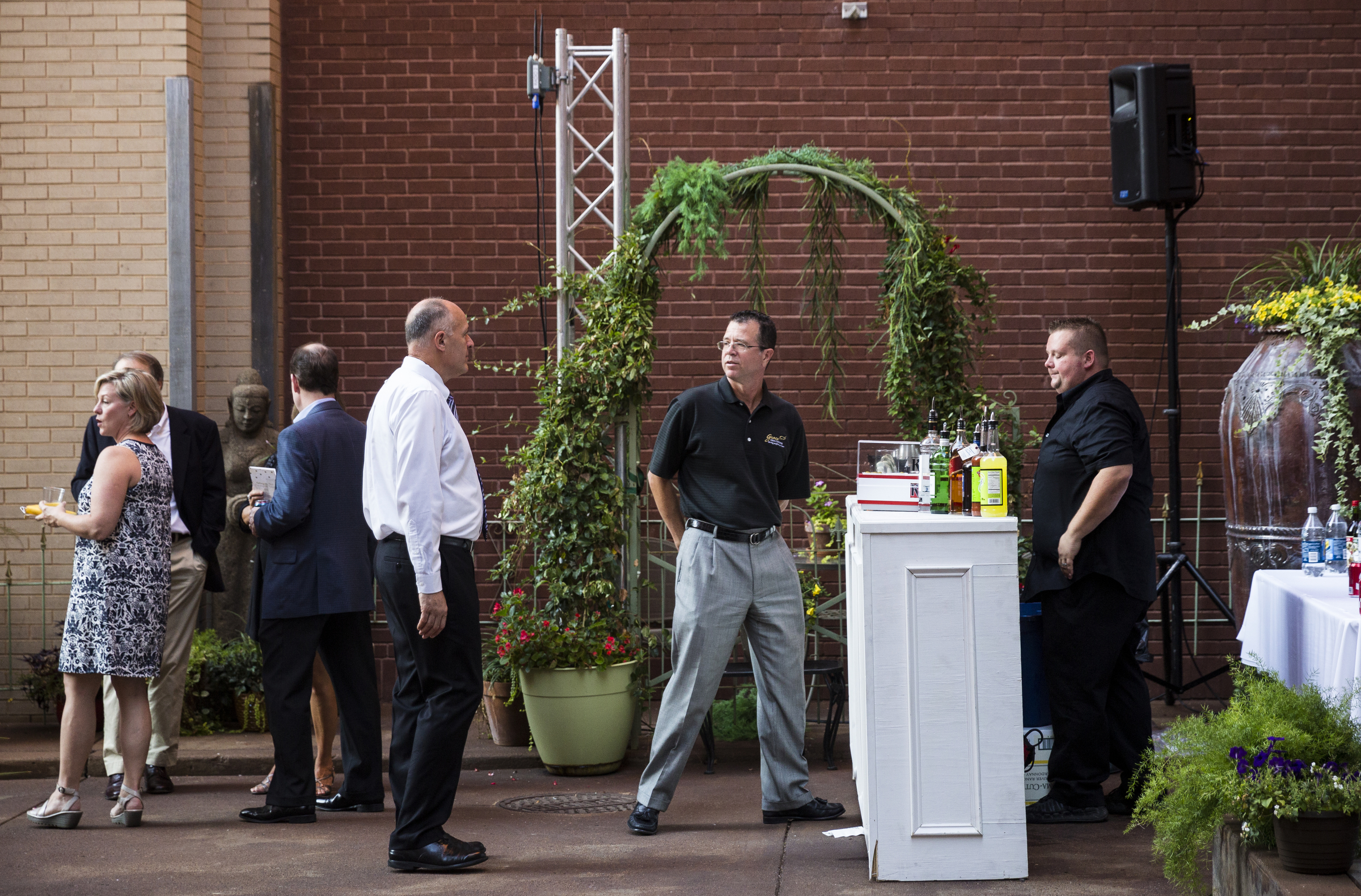 People are served drinks in a decorated alley at the "Remembering the Past, Celebrating the Future" fundraiser to raise money for WTCI held on the newly repaved section of Chestnut Street between Martin Luther King, Jr., Boulevard and 8th Street on Saturday, Sept. 24, 2016, in Chattanooga, Tenn. The fundraiser featured music from Arlo Guthrie, the Dismembered Tennesseans, and Priscilla and Little Rickee.
