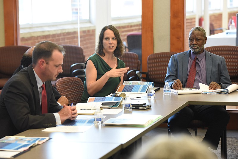 Keri Randolph, center, speaks during a meeting about Chatt 2.0 on Friday at the Times Free Press Jared Bigham, left, and Kirk Kelly listen.