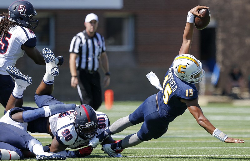 UTC quarterback Alejandro Bennifield stretches for a first down as he is tackled by Samford defensive lineman Xavier Forrest during the Mocs' home football game against the Bulldogs at Finley Stadium on Saturday, Sept. 24, 2016, in Chattanooga, Tenn.