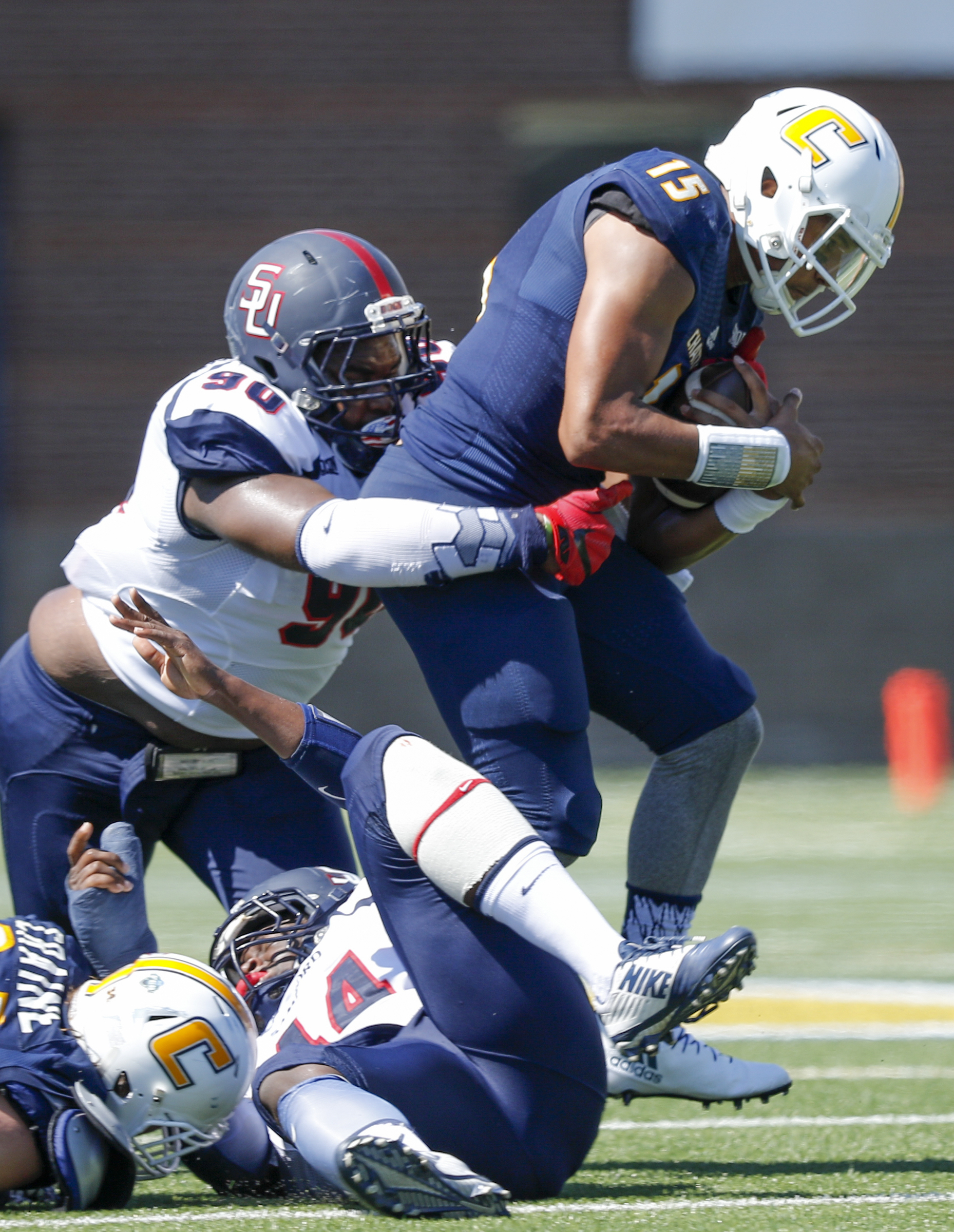 Samford defensive lineman Xavier Forrest tackles UTC quarterback Alejandro Bennifield during the Mocs' home football game against the Bulldogs at Finley Stadium on Saturday, Sept. 24, 2016, in Chattanooga, Tenn.