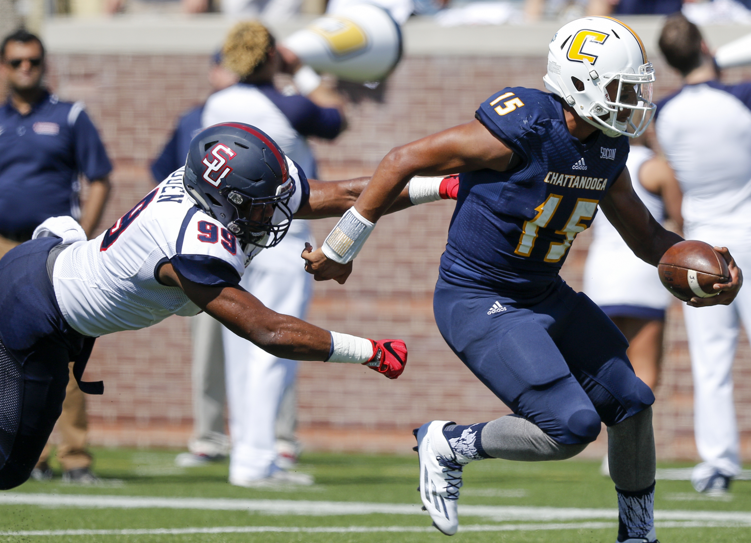 UTC quarterback Alejandro Bennifield rushes ahead of Samford defensive lineman Ahmad Gooden during the Mocs' home football game against the Bulldogs at Finley Stadium on Saturday, Sept. 24, 2016, in Chattanooga, Tenn.