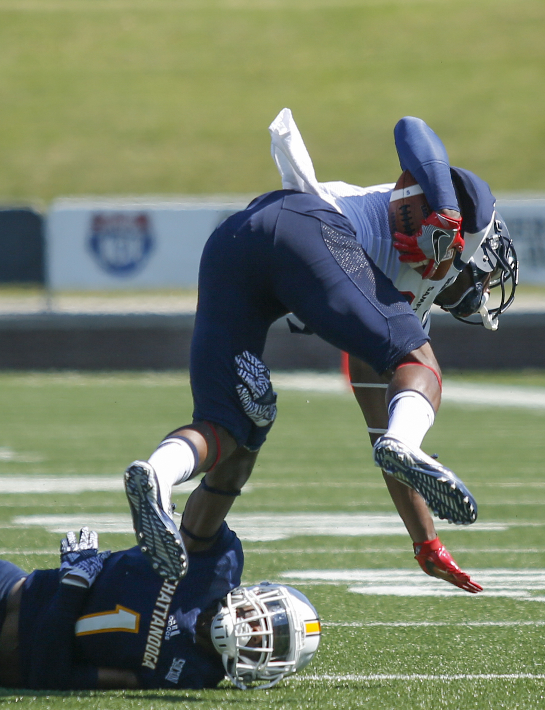 UTC defensive back Trevor Wright upends Samford's Kelvin McKnight during the Mocs' home football game against the Bulldogs at Finley Stadium on Saturday, Sept. 24, 2016, in Chattanooga, Tenn.