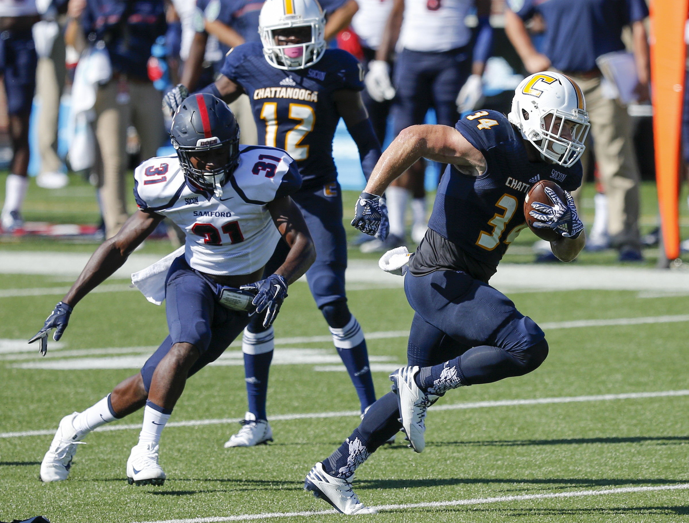 UTC running back Derrick Craine breaks away from Samford defensive back Jamond Glass for a touchdown run during the Mocs' 41-21 Southern Conference win Saturday afternoon at Finley Stadium.