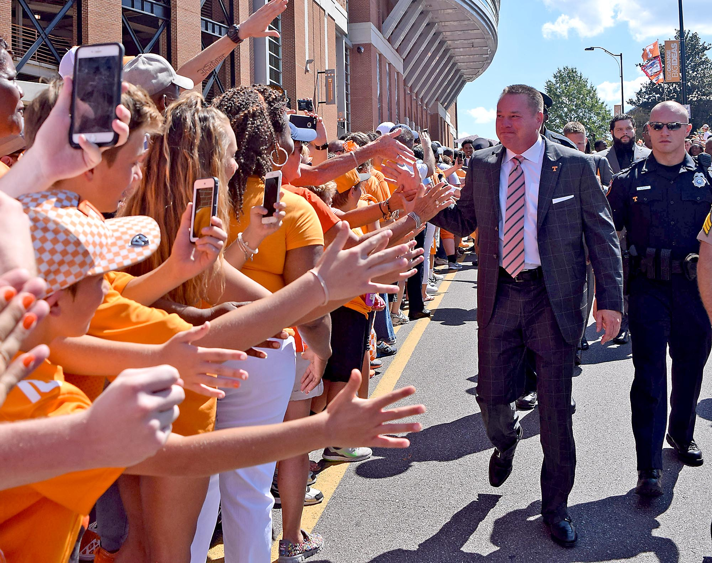 Tennessee head coach Butch Jones is greeted by hands and iPhones as he makes his way down the Vol walk. The Florida Gators visited the Tennessee Volunteers in a important SEC football contest at Neyland Stadium on September 24, 2016.